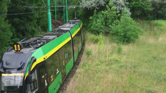 Poznan, Poland, July 5, 2022: Public transport in the city. Eco electric tram on rails. Green zero emmission passenger transportation train. European commute system.