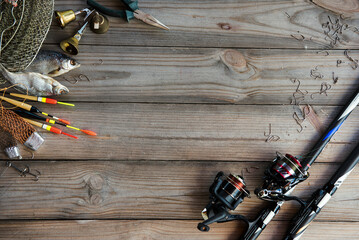 Fishing tackle background. Lifestyle. Spinning, hooks. Accessories for fishing on the wooden background. . Active hobby recreation concept. Top view, flat lay. © Oksana