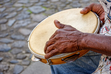Hands and instrument of percussionist playing tambourine in the streets of the famous Pelourinho...