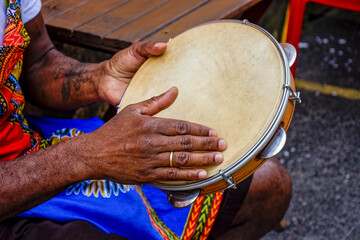 Percussionist playing tambourine in the famous streets of Pelourinho district in city of Salvador, Bahia