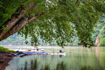 Fototapeta na wymiar These wooden boats are docked by the river in the wild mountains