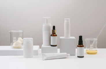 Cosmetic laboratory research and development. Cosmetic bottle containers with blank label for branding mock-up. Natural cosmetics with herbal ingredients.
