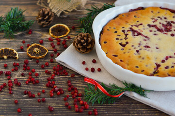Traditional homemade Christmas cake on a white plate festive dessert with cranberries on the background of Christmas decorations