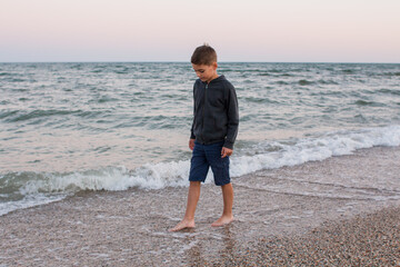 boy on the sea beach in the evening in raglan on the shore