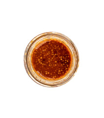 Top view of Bavarian mustard in an open glass jar on a white background.