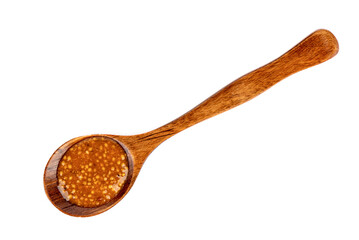 Top view of a wooden spoon with bavarian mustard on a white background.