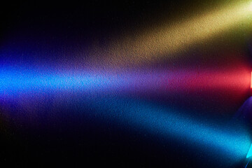 Naklejka premium On a black background, multi-colored broadish gradient rays of light with a transition at one point
