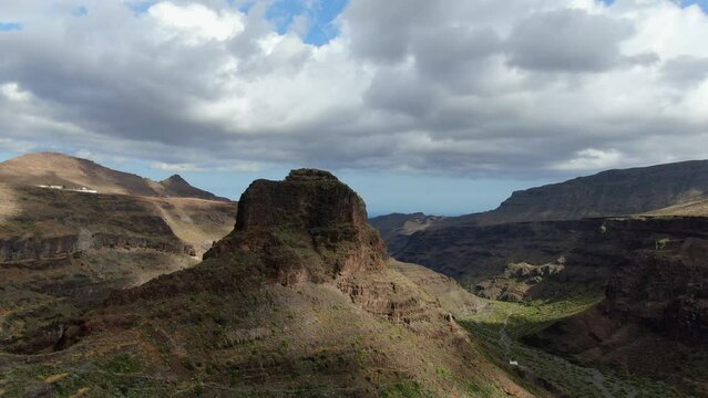 Ansite Fortress, aerial shot in orbit of the mountain located near the Ansite Fortress on the island of Gran Canaria. Ancient Aboriginal caves are found inside. Monument recognized by Unesco.