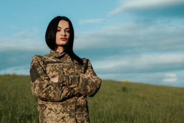 Female soldier standing with crossed arms dressed in military uniform. Armed Forces of Ukraine....