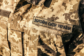 Close up velcro patch on military uniform soldiers arm. Armed Forces of Ukraine. Woman serving in ukrainian army.

