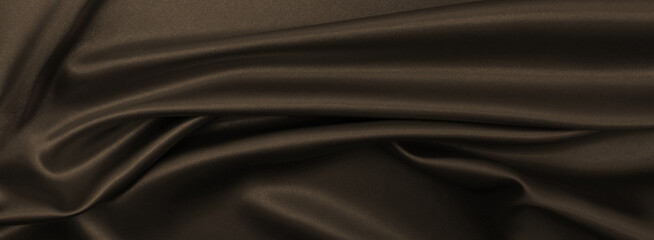 Obraz premium Smooth elegant brown silk or satin texture as abstract background. Luxurious background design wallpaper. In Sepia toned. Retro style