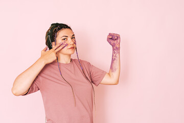 Girl with a purple hand and a venus mirror sign against a pink background.