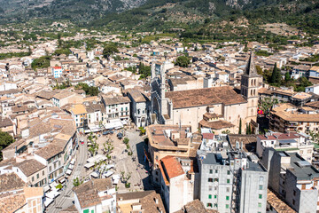 Fototapeta na wymiar Helicopter view of the old town of Sóller, with the Church of St. Bartholomew, Roman Catholic parish church, Sóller, mountains behind, Serra de Tramuntana, Mallorca, Balearic Islands, Spain