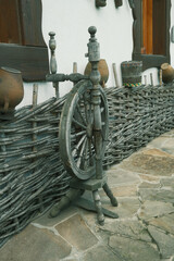 Traditional Ukrainian spinning wheel near the national house. Ancient Yarn Tool