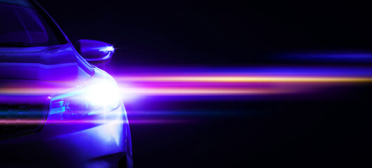 Car headlights with light rays and copy space, banner. Neon light of car headlights on a dark...