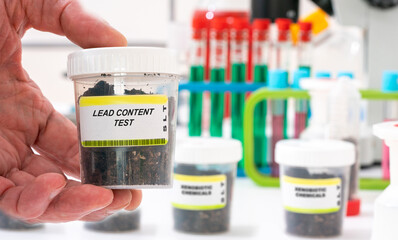 Lead. Lead content in soil sample in plastic container. Study of agricultural soil in a chemical laboratory