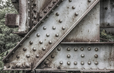 Steel girders and rivets of an old railway bridge
