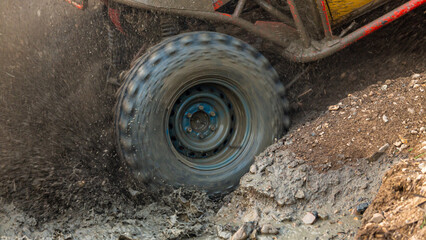 Fototapeta na wymiar Motion the wheels tires off road water and mud splash, 4x4 or 4WD car with wheels in mud off road, Car stuck in puddle of mud, Wheel covered with dirt.