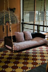 Vertical shot of the interior of a vintage hotel a swinging seat in India