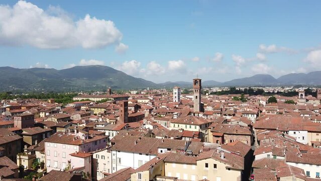 Panoramic view over the rooftops of Lucca, Italy from Torre Guinigi - Pan from left to right