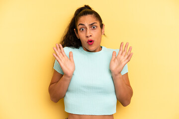 hispanic pretty woman looking shocked and astonished, with jaw dropped in surprise when realizing...