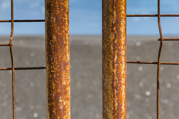 Rusting of iron fence with corrosion, selective focus.