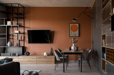 Living room with table and rusty colored wall