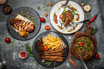 Set Georgian dishes chakapuli, shish kebab and meat chop steak with walnut sauce on a dark background. banner, menu, recipe place for text, top view