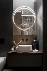 Elegant, round led lamp in modern bathroom