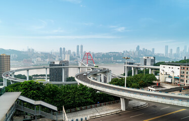 the circular overpass and the urban skyline are in Chongqing, China