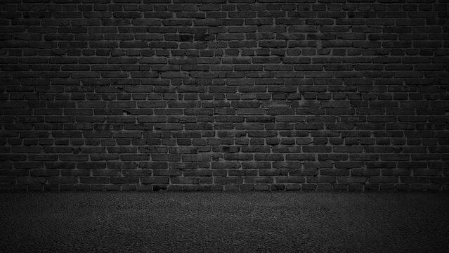 The dark studio is a moving black brick wall and an asphalt floor.