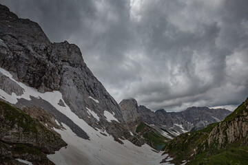 Mountain hiking Trail Road. Grey sky before thunderstorm. Between Italy and Austria: near Volaia Lake Raunchkofer Mountain (Lago di Volaia Monte Rauchkofel)