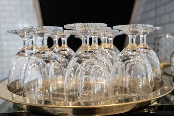 Celebration, many empty glasses of wine. Many glasses  in a row on bar counter for night party.New years,Christmas party.Wine glasses in tray prepare for people.