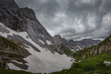 Mountain hiking Trail Road. Grey sky before thunderstorm. Between Italy and Austria: near Volaia Lake Raunchkofer Mountain (Lago di Volaia Monte Rauchkofel)