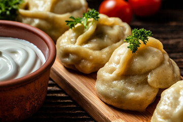 Traditional manti food on plate, top view. The concept of oriental cuisine. Uzbek food manty dumplings. Uzbek food. banner, catering menu recipe place for text - obrazy, fototapety, plakaty
