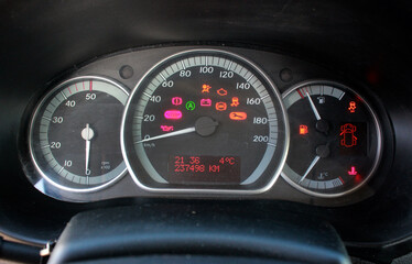 A close-up of a car panel with a speedometer indicating, oil and gasoline levels. Car panel,...