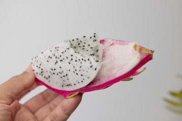 Peeling pitaya or dragon fruit in hand