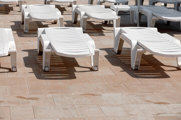 Sun loungers along the pool with turquoise water.