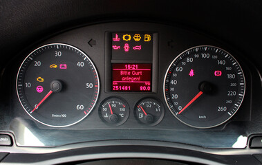 A close-up of a car panel with a speedometer indicating, oil and gasoline levels. Car panel, digital bright speedometer, odometer and other tools.