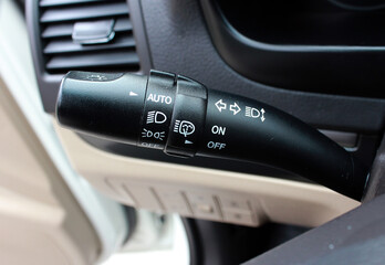 Car interior with light switch. Modern car headlight controls. Automobile interior detail. Car fog lights switch.