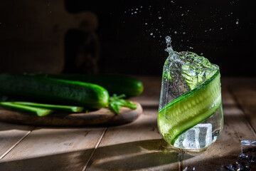 cucumber soft summer drink on a dark background