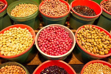 A pile of shiny Syrian green olives, full of oil. No kernels. Blurred background. Arabic style. The Old Market of Mahane Yehuda, Jerusalem. High quality photo