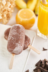  Fresh summer dessert. Melting natural cocoa ice-cream glazed in molk chocolate, top view. Healthy  sweet food concept.        