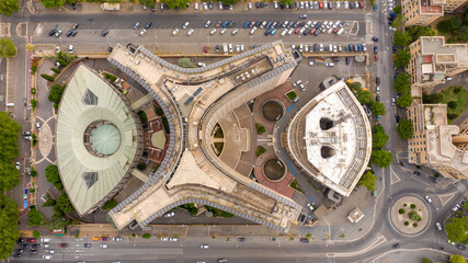 Perpendicular aerial view on a futuristic building with irregular and curved shapes.