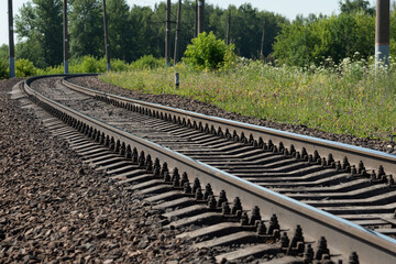 Metal rails of a railway train, road into the distance, railway station