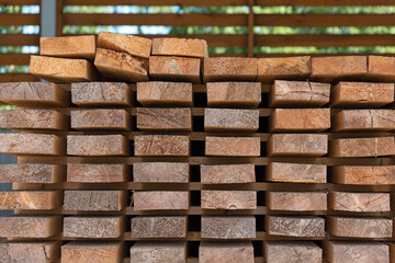 Smooth wooden flat boards in a warehouse, front view, close up