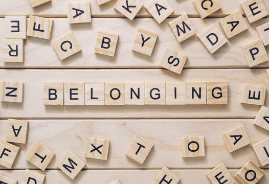 Word Belonging Made With Letter Blocks On Wooden Background