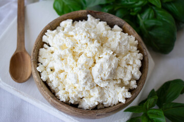 cottage cheese with basil on a white table