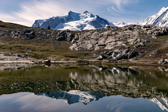 Mountains of the Alps reflecting on the water of the Riffelsee Lake near Zermatt, Switzerland 