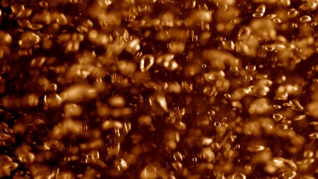 Golden orange beer bubbles swirling in a refreshing cool full-frame macro alcoholic beverage. 3D animation loop concept. Extreme close-up cut-in and cutaway shot of sparkling effervescent soda fizz.